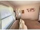 Bedroom features a glimpse of the bathroom, neutral walls, and a comfortable bed at 224 Montana Ave, St Cloud, FL 34769