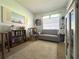 Comfortable bedroom with a cozy couch, decorative accents, and soft carpet at 224 Montana Ave, St Cloud, FL 34769