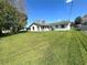 Home exterior surrounded by a green lawn and chain link fence at 224 Montana Ave, St Cloud, FL 34769