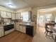 Traditional kitchen with white cabinets, wood counters, and a cozy dining area at 224 Montana Ave, St Cloud, FL 34769