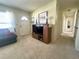 Cozy living room features carpet, a sofa, and a television on a wood entertainment stand at 224 Montana Ave, St Cloud, FL 34769