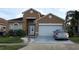 Charming two-story home featuring an attached two-car garage and well-maintained front yard at 2244 Mallard Creek Cir, Kissimmee, FL 34743
