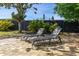 Beautiful backyard patio area with pavers and 2 lounge chairs for relaxing outdoors at 2313 Duncan Trl, Clermont, FL 34714