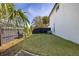 Spacious backyard with green lawn, privacy fence, lush landscaping and tropical trees at 2313 Duncan Trl, Clermont, FL 34714