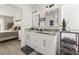 Bathroom featuring double vanity sinks, modern fixtures, and an open view to a bedroom at 2313 Duncan Trl, Clermont, FL 34714