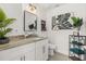 Elegant bathroom with granite countertop, mirror, decorative plants, and a shelf with rolled towels at 2313 Duncan Trl, Clermont, FL 34714