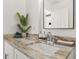 Close up on a marble countertop with a sink, faucet, and decor in a bright bathroom at 2313 Duncan Trl, Clermont, FL 34714