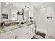 Bright bathroom with dual sinks, white cabinets, walk-in shower and clean modern finishes at 2313 Duncan Trl, Clermont, FL 34714