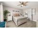 Cozy bedroom with a queen-size bed, soft lighting, and an en-suite bathroom at 2313 Duncan Trl, Clermont, FL 34714