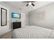 Nicely decorated bedroom features a ceiling fan, television, and wood-look flooring for comfortable living at 2313 Duncan Trl, Clermont, FL 34714