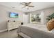 Comfortable bedroom with a light bedspread, window view and a television on the wall at 2313 Duncan Trl, Clermont, FL 34714