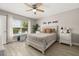 Bright bedroom with a queen-size bed, natural light from window, and decorative wall art at 2313 Duncan Trl, Clermont, FL 34714