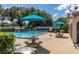 Inviting community pool with picnic tables, umbrellas, and lounge chairs at 2313 Duncan Trl, Clermont, FL 34714