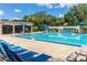 Large community pool with plenty of seating and umbrellas at 2313 Duncan Trl, Clermont, FL 34714