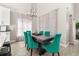 Dining room with stylish teal chairs and modern chandelier for a unique look at 2313 Duncan Trl, Clermont, FL 34714