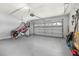 Spacious two car garage with painted walls, gray floors, and ample room for storage at 2313 Duncan Trl, Clermont, FL 34714