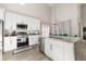 Kitchen with white cabinets, stainless steel appliances, and an island with a sink and dishwasher at 2313 Duncan Trl, Clermont, FL 34714