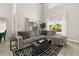Inviting living room featuring a comfortable sectional sofa and sunlit windows with backyard views at 2313 Duncan Trl, Clermont, FL 34714