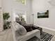 Bright living room with plush sectional sofa, wooden floors and large windows overlooking landscaped yard at 2313 Duncan Trl, Clermont, FL 34714
