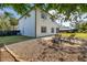 Charming patio space with lounge chairs, surrounded by lush greenery and landscaped grounds at 2313 Duncan Trl, Clermont, FL 34714