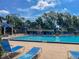 Community pool with ample seating and pristine water provides a refreshing oasis for residents at 2313 Duncan Trl, Clermont, FL 34714