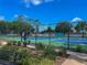 Community tennis courts surrounded by lush landscaping and secure fencing, perfect for tennis enthusiasts at 2313 Duncan Trl, Clermont, FL 34714