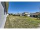 Spacious backyard with a view of neighboring houses and a lush green lawn at 2372 Sirena Ln, Mount Dora, FL 32757