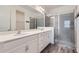 A spacious bathroom is equipped with double sinks, and glass enclosed shower at 2372 Sirena Ln, Mount Dora, FL 32757