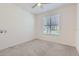 Empty bedroom with neutral carpet, a window, and white walls, ready for personalization at 2372 Sirena Ln, Mount Dora, FL 32757