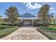 Elegant clubhouse exterior with beautiful landscaping and a welcoming entrance at 2372 Sirena Ln, Mount Dora, FL 32757