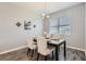Bright dining area features a modern chandelier and decorative wall art at 2372 Sirena Ln, Mount Dora, FL 32757