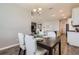 Bright dining area is open to kitchen, featuring a modern chandelier at 2372 Sirena Ln, Mount Dora, FL 32757