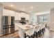 Modern kitchen boasts stainless steel appliances, granite countertops, and island seating at 2372 Sirena Ln, Mount Dora, FL 32757