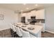 Modern kitchen featuring white cabinets, stainless steel appliances, and a large center island with barstool seating at 2372 Sirena Ln, Mount Dora, FL 32757