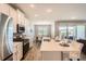 Bright kitchen with a large island, stainless steel appliances, and an adjacent dining area with sliding glass doors at 2372 Sirena Ln, Mount Dora, FL 32757