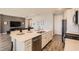 Contemporary kitchen featuring a large island with seating, stainless steel appliances, and a view into the living area at 2372 Sirena Ln, Mount Dora, FL 32757