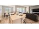 Open concept kitchen with island seating, stainless steel sink, and views of dining and living areas at 2372 Sirena Ln, Mount Dora, FL 32757