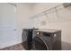 Convenient laundry room with gray front load washer and dryer, plus overhead storage rack at 2372 Sirena Ln, Mount Dora, FL 32757