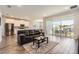 Inviting open-concept living room with hardwood floors and sliding glass doors at 2372 Sirena Ln, Mount Dora, FL 32757