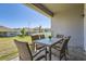 Relaxing outdoor patio with a dining table and chairs overlooking the spacious backyard at 2372 Sirena Ln, Mount Dora, FL 32757