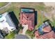 Aerial shot of the property showcasing its layout, tile roof, and a screened-in pool at 2375 Pinehurst Ct, Davenport, FL 33837