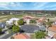 Aerial view showing tile-roofed homes surrounding a cul-de-sac with mature trees and a golf course at 2375 Pinehurst Ct, Davenport, FL 33837