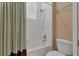 Clean bathroom showcasing the toilet, bathtub and shower, and neutral color palette at 2375 Pinehurst Ct, Davenport, FL 33837