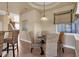 Bright breakfast nook features a glass table, woven chairs, and elegant lighting at 2375 Pinehurst Ct, Davenport, FL 33837