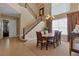 Dining area with a large window, chandelier, and staircase at 2375 Pinehurst Ct, Davenport, FL 33837
