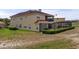 Two-story home showcasing a screened lanai and terra cotta roof tiles at 2375 Pinehurst Ct, Davenport, FL 33837