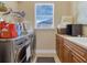 Well-organized laundry room with front-load washer and dryer, storage cabinets, and a bright window at 2375 Pinehurst Ct, Davenport, FL 33837