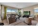Open living room with a large window view, comfortable seating and a flat-screen TV at 2375 Pinehurst Ct, Davenport, FL 33837