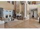 Spacious living room with high ceilings, fireplace, and French doors at 2375 Pinehurst Ct, Davenport, FL 33837