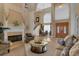 Elegant living room with fireplace, high ceilings and grand staircase at 2375 Pinehurst Ct, Davenport, FL 33837